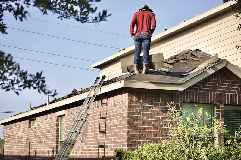 Professional roofer working on a residential roof in Fultonham